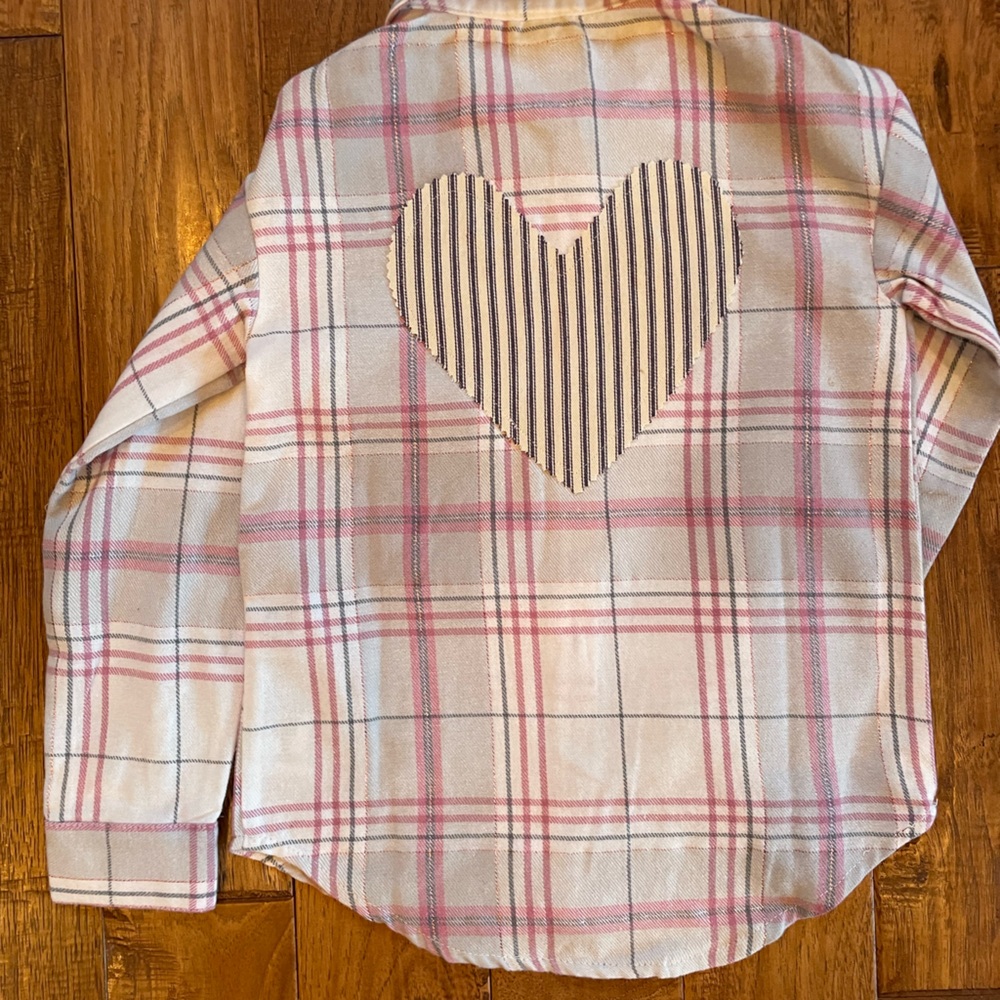 Girls XS Levi's button down long sleeve shirt with heart sewn on the back.